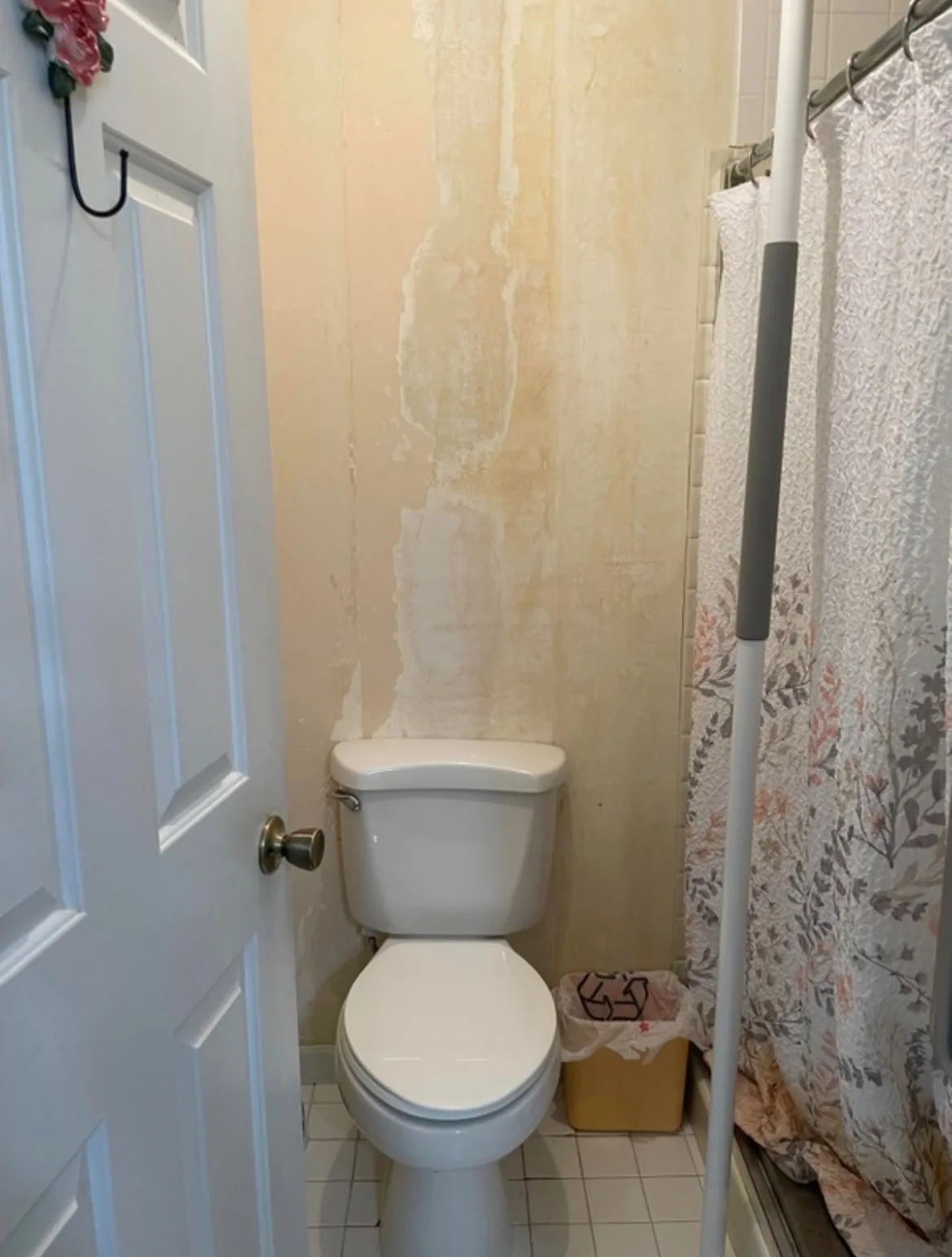 Before: bathroom with peeling paint above the shower