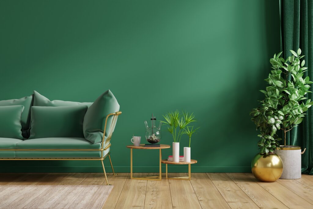 Interior mockup green wall with green sofa and decor in living room.